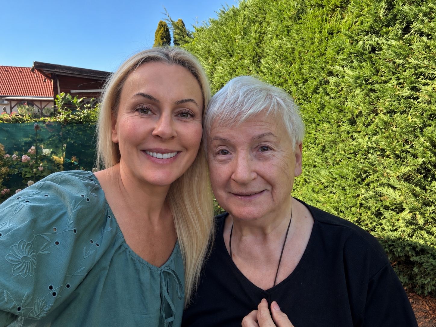 Orshi McNaughton with her mom in a garden in Hungary.